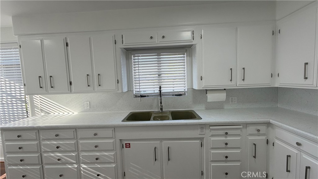 3590 Buchanan Street Riverside, CA 92503 - Photo 21 of 73 a kitchen with granite countertop white cabinets and window