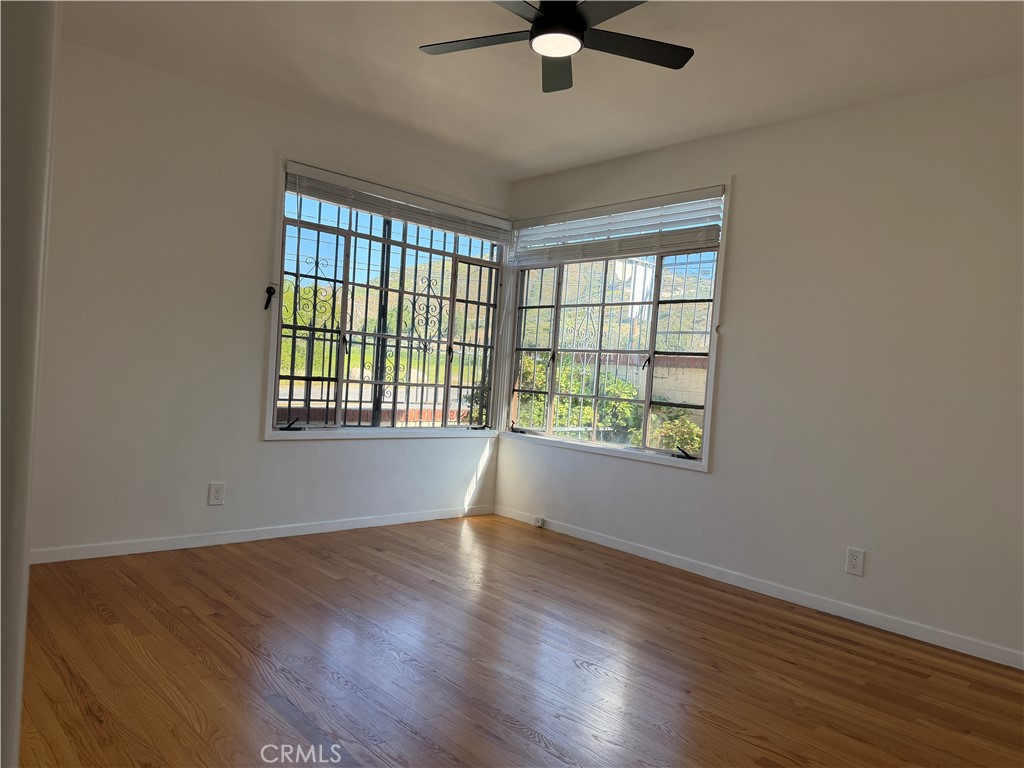 3590 Buchanan Street Riverside, CA 92503 - Photo 25 of 73 a view of an empty room with wooden floor and a window