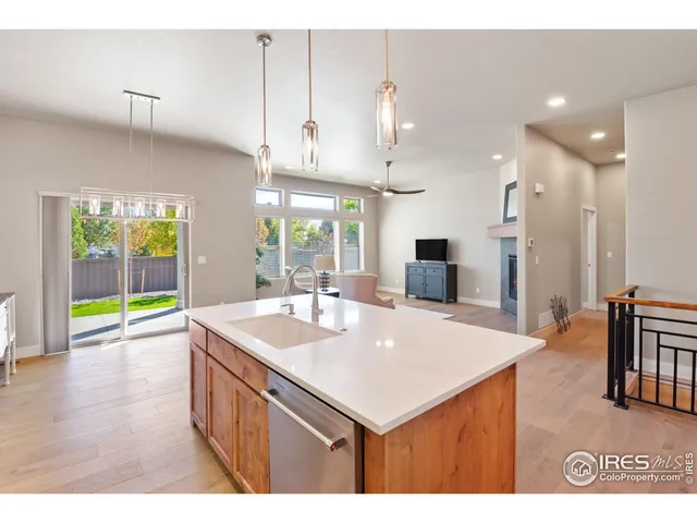 a kitchen with stainless steel appliances granite countertop a sink a stove a refrigerator and island