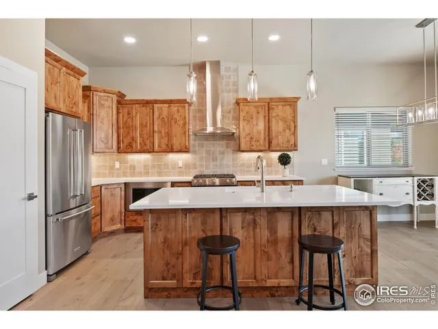 a kitchen with a sink cabinets and wooden floor