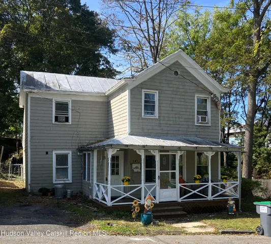 a view of a house with a yard and sitting area