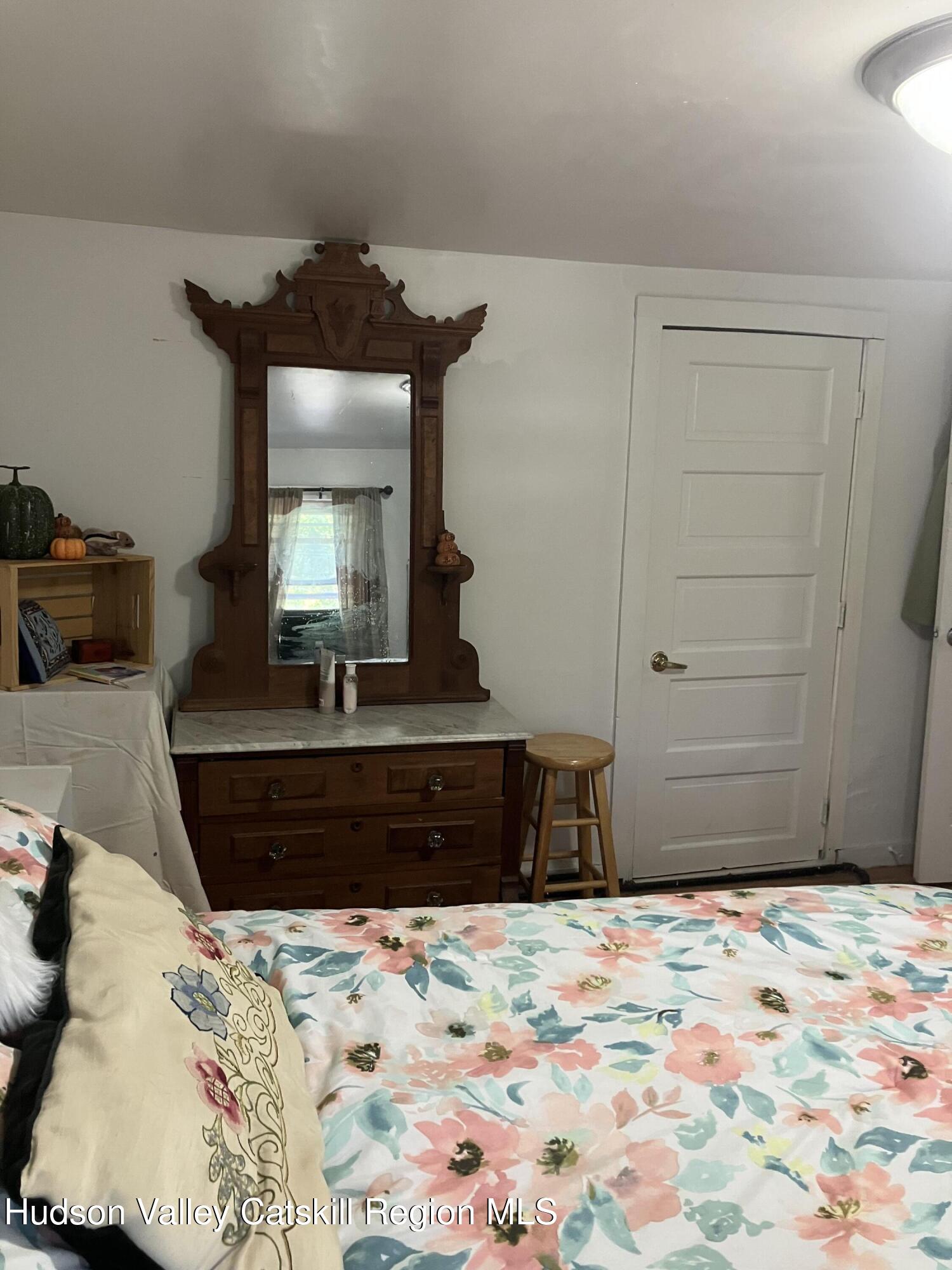 147 North Street Catskill, NY 12414 - Photo 18 of 23 a bedroom with a bed and a dresser