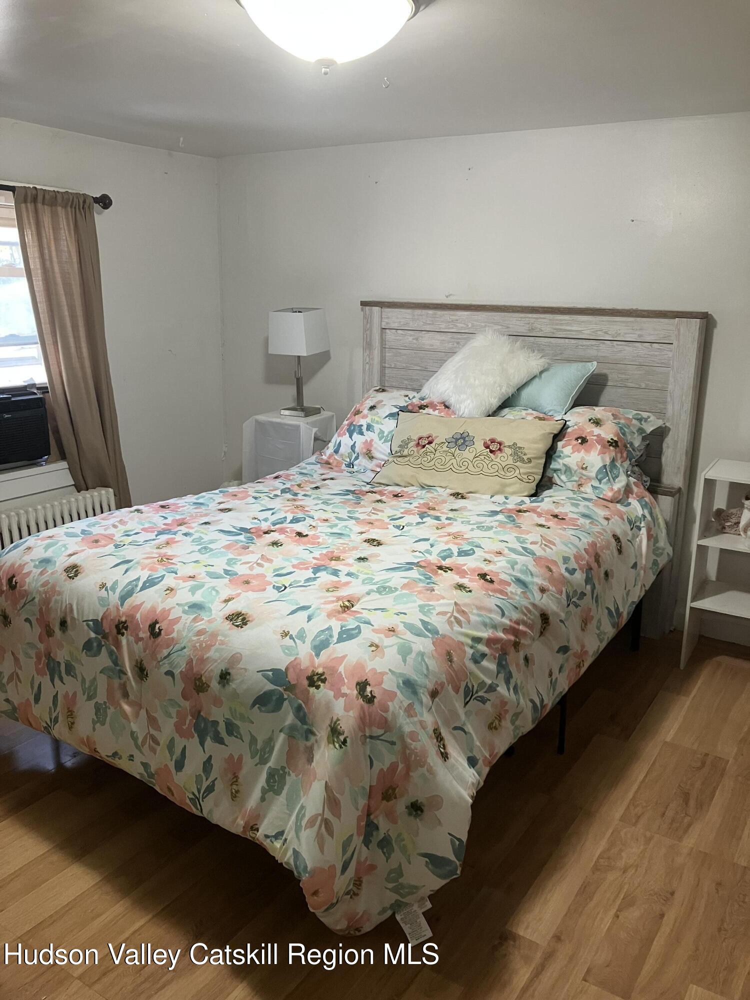 147 North Street Catskill, NY 12414 - Photo 19 of 23 a bedroom with a bed and wooden floor