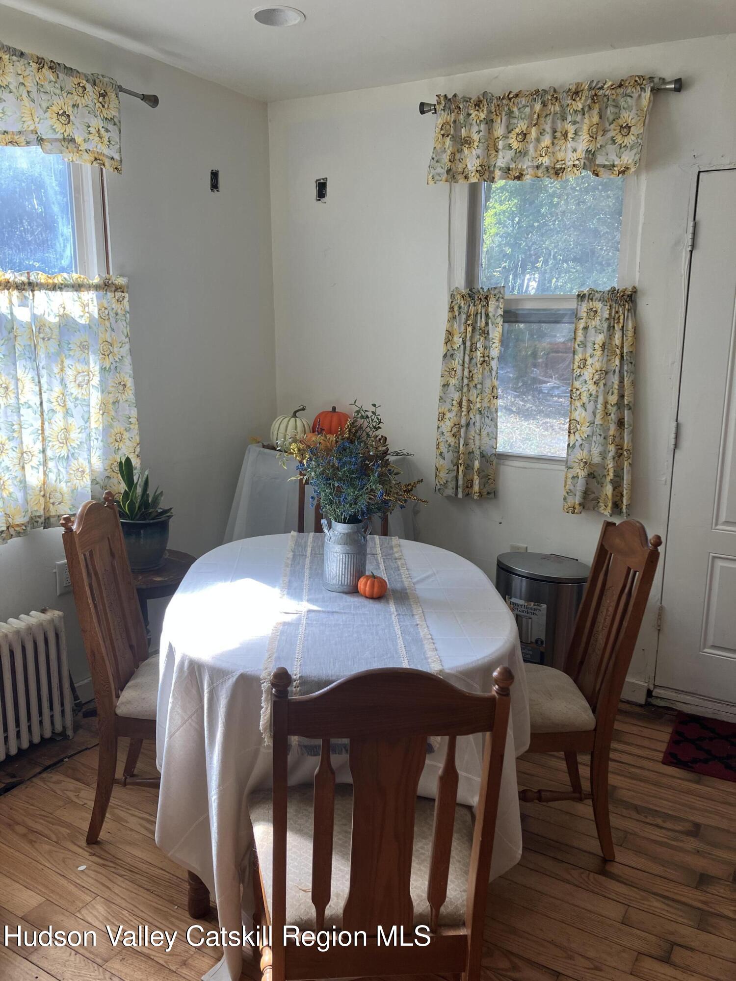147 North Street Catskill, NY 12414 - Photo 21 of 23 a view of a dining room with furniture window and wooden floor