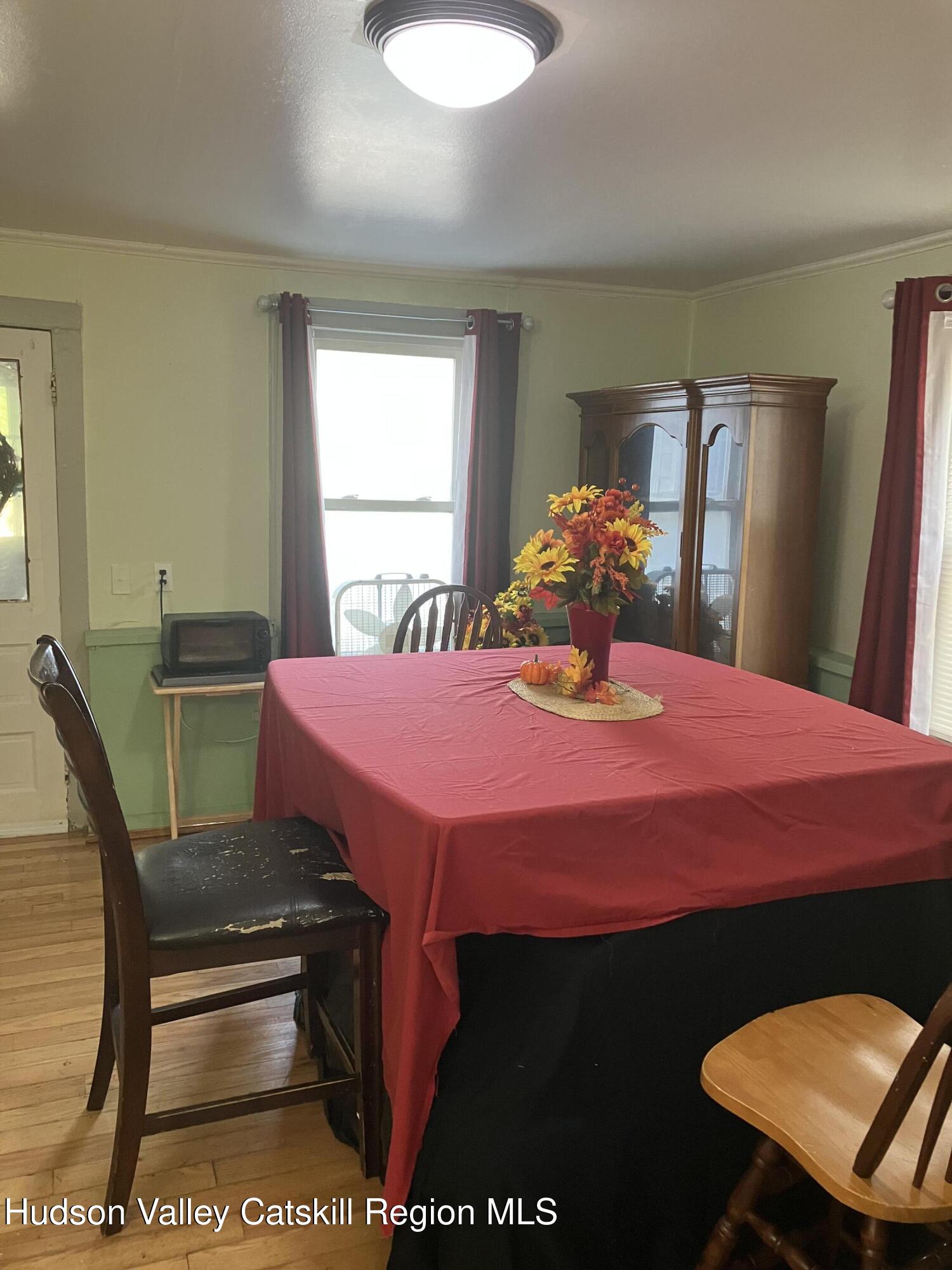 147 North Street Catskill, NY 12414 - Photo 8 of 23 a bedroom with a bed a table and chair