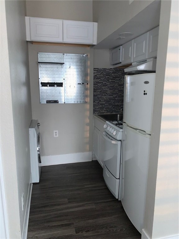a kitchen with wooden floor and electronic appliances