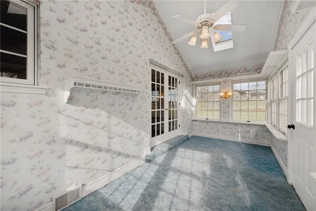 a kitchen with granite countertop white cabinets and a stove