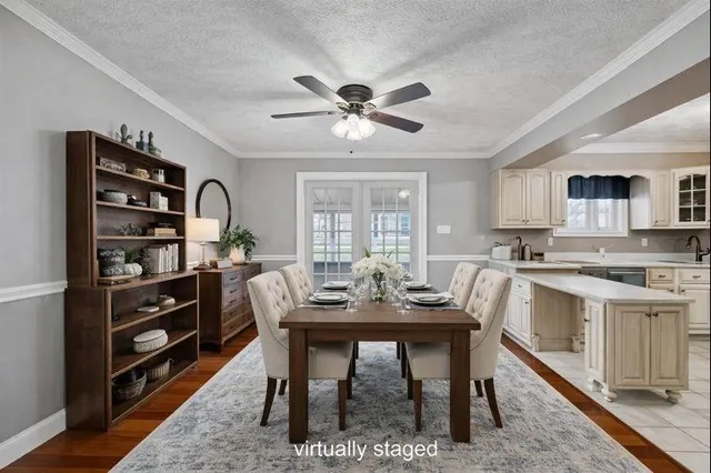 a large white kitchen with stainless steel appliances a stove refrigerator and cabinets