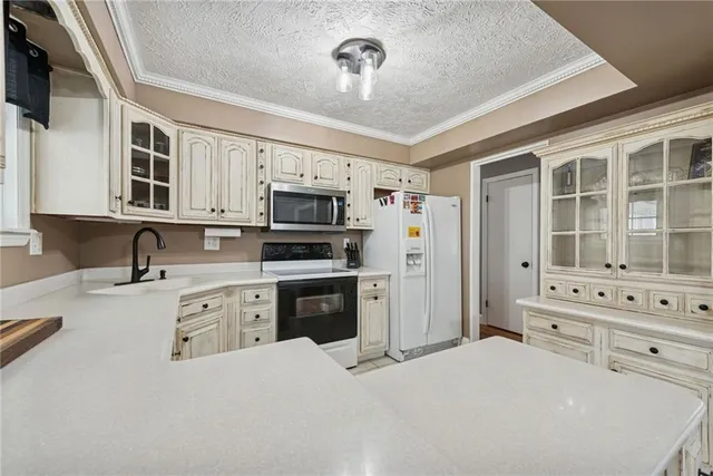 a kitchen with stainless steel appliances granite countertop a stove sink and cabinets