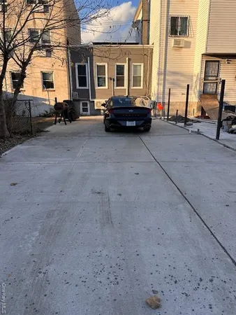 a car parked in front of a brick house