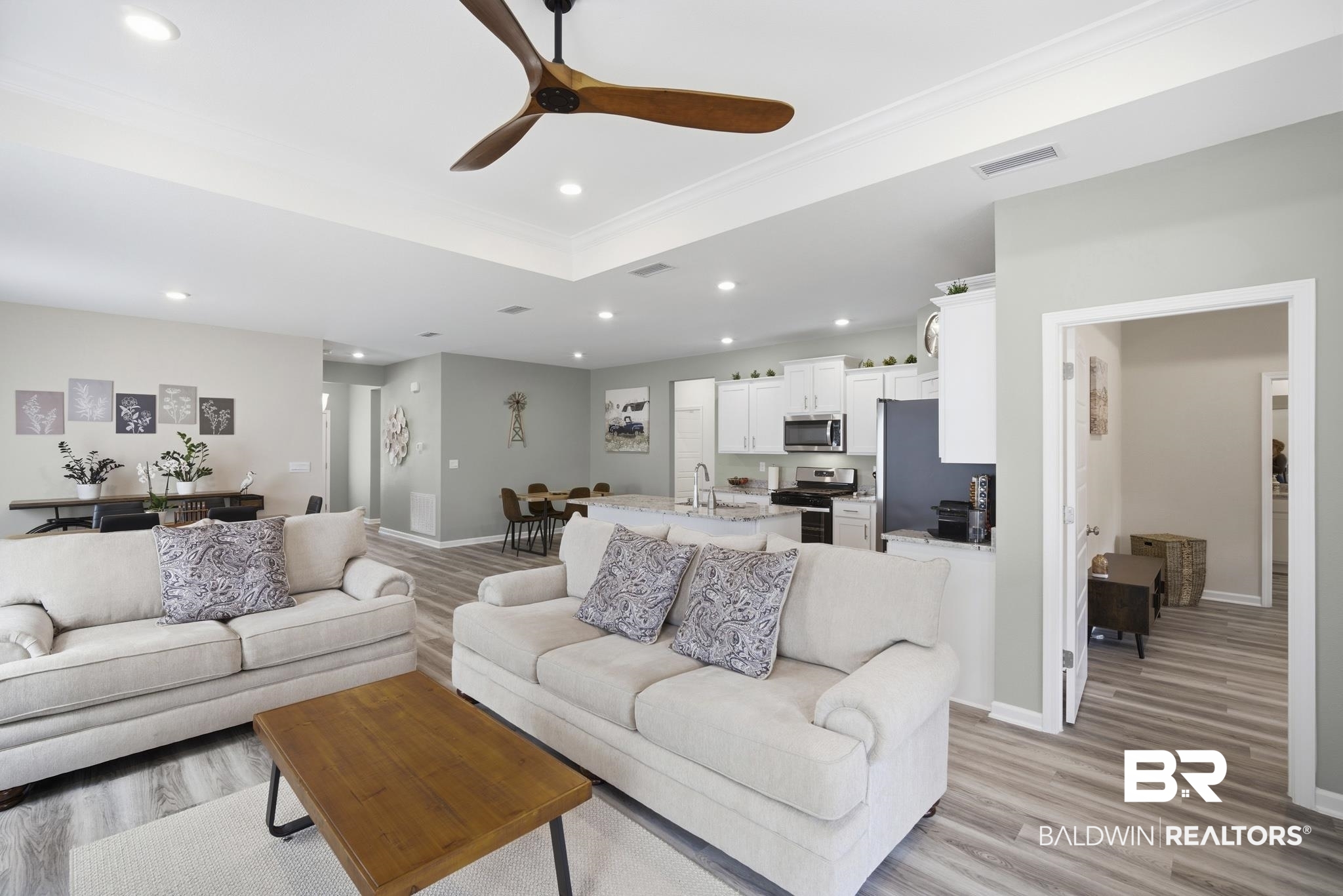13887 Antler Hl Road Daphne, AL 36527 - Photo 7 of 50 Living room featuring a raised ceiling, ceiling fan, light wood-style floors, crown molding, and recessed lighting