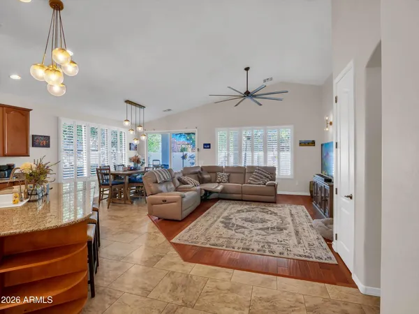 a kitchen with stainless steel appliances granite countertop a refrigerator stove and sink