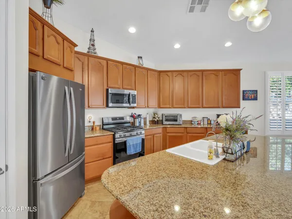 a kitchen with a sink cabinets and wooden floor