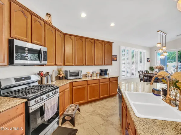 a view of a dining room with furniture and a chandelier