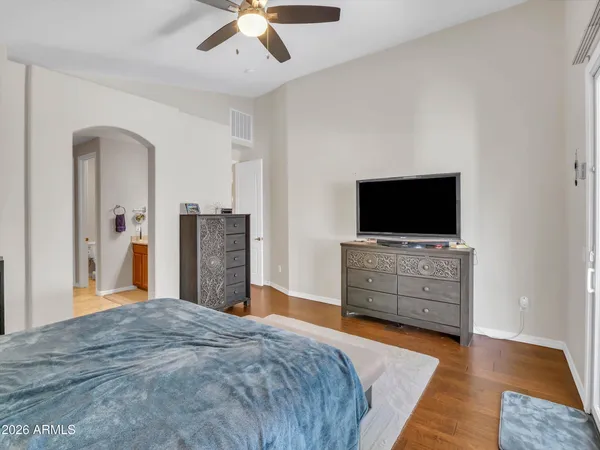 a white toilet sitting next to a white wall