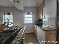 a view of a kitchen and a window in the living room