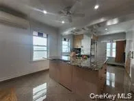 a kitchen with granite countertop a stove and a refrigerator