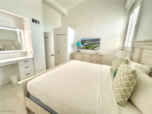 a bedroom with a large bed and a window
