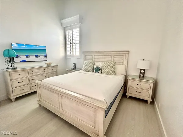 a large white bed in a white room