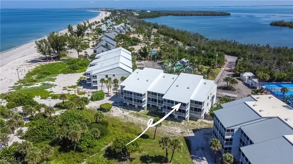 an aerial view of a house with a garden and lake view
