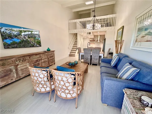 a living room with furniture a couch and a flat screen tv