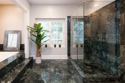 a bathroom with a granite countertop sink a mirror and a vanity