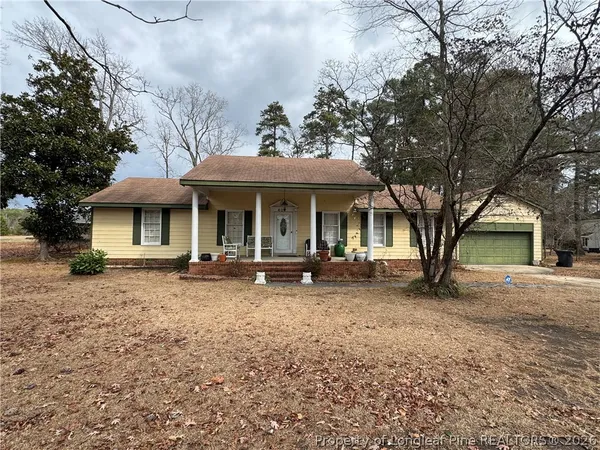 a front view of a house with yard porch and furniture