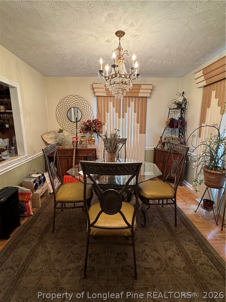 408 Old Farm Road Raeford, NC 28376 - Photo 12 of 27 a view of a dining room with furniture and a chandelier
