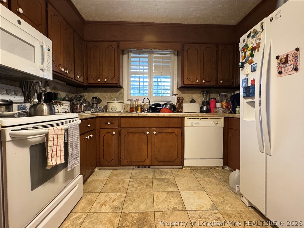 408 Old Farm Road Raeford, NC 28376 - Photo 14 of 27 a kitchen with a sink stove and cabinets