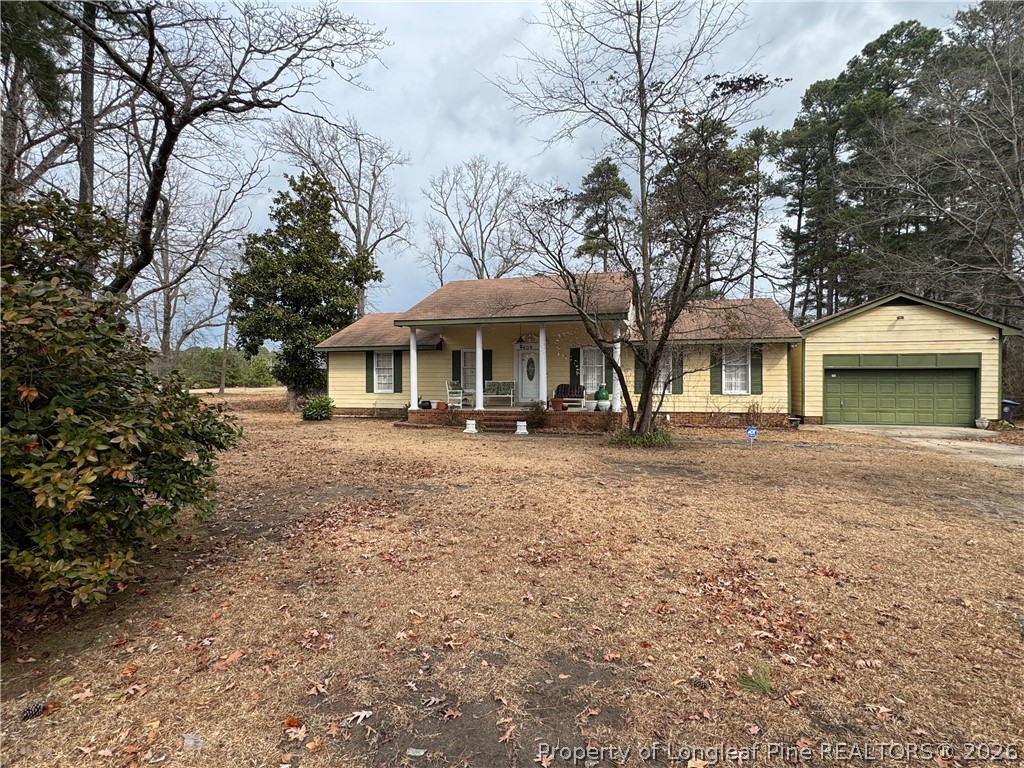 408 Old Farm Road Raeford, NC 28376 - Photo 2 of 27 a front view of a house with garden