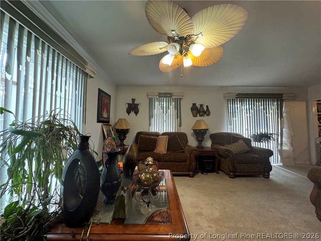 408 Old Farm Road Raeford, NC 28376 - Photo 22 of 27 a living room with furniture a chandelier and a large window