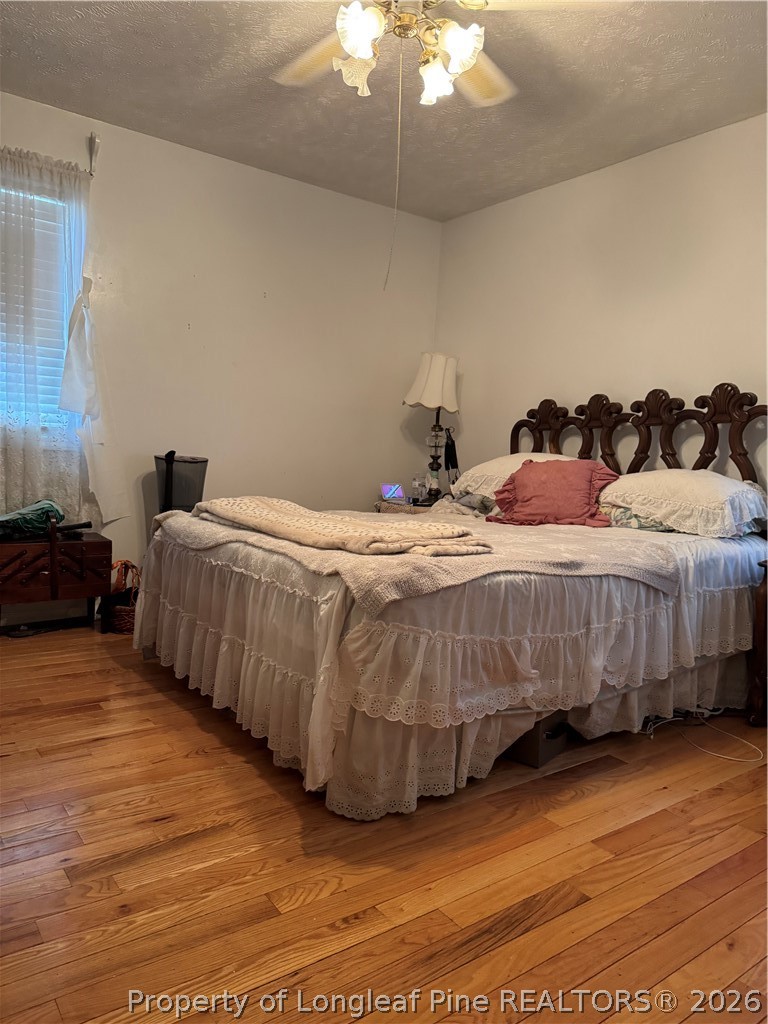 408 Old Farm Road Raeford, NC 28376 - Photo 25 of 27 a bedroom with a bed and a chandelier