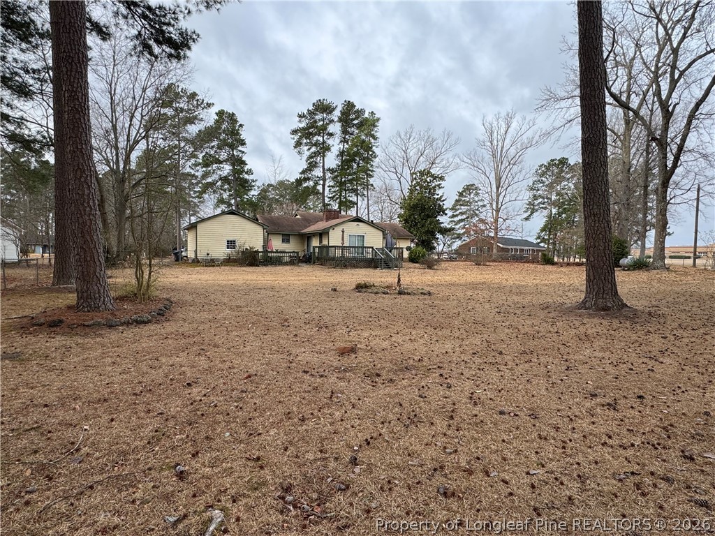 408 Old Farm Road Raeford, NC 28376 - Photo 7 of 27 a view of dirt yard with a tree