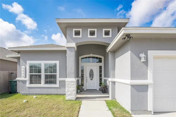a front view of a house with a yard