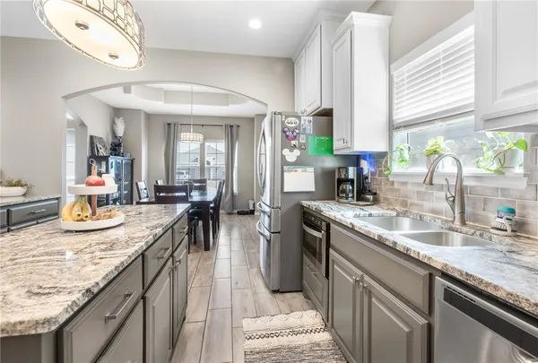 a kitchen with sink stove and cabinets