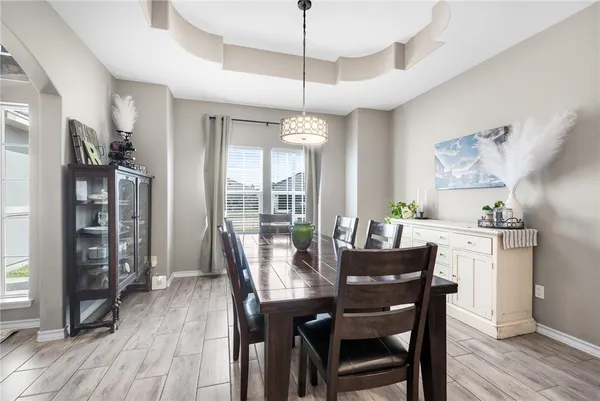 a dining room with furniture window and wooden floor