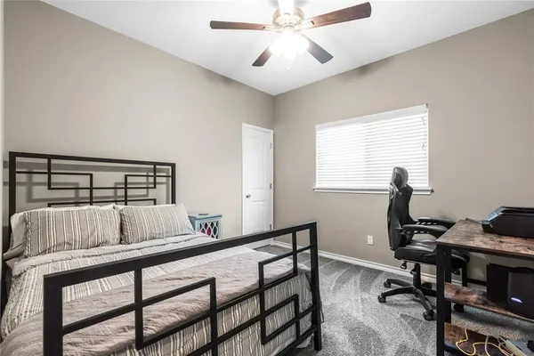 a bedroom with a bed and a desk