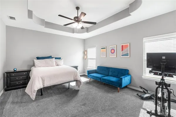 a bedroom with furniture and a large window