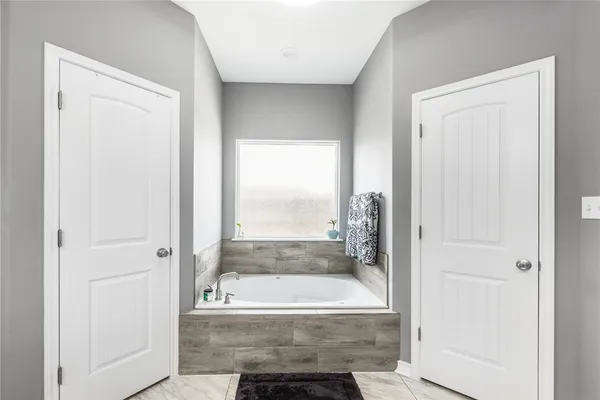 a bathroom with a bathtub and shower