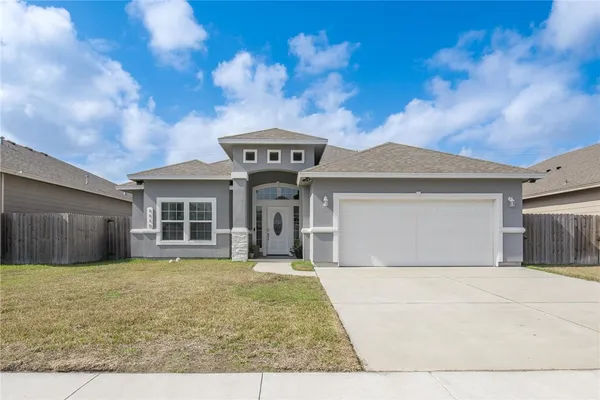 a front view of a house with a yard and garage