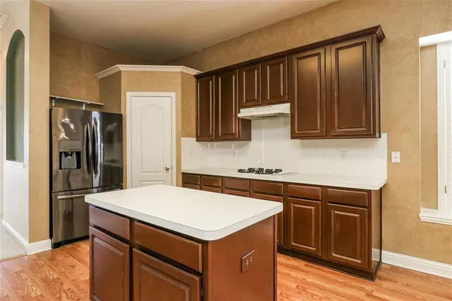 a kitchen with stainless steel appliances a sink and a refrigerator