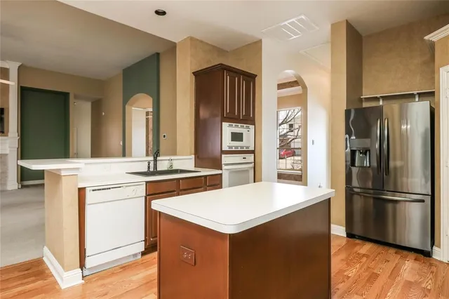 a kitchen with a refrigerator and a sink