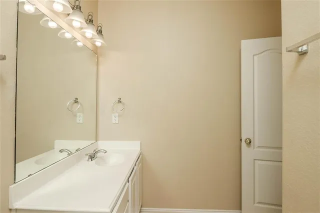 a bathroom with a sink a mirror and a shower
