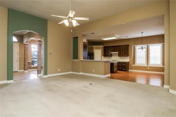 an empty room with windows and fireplace