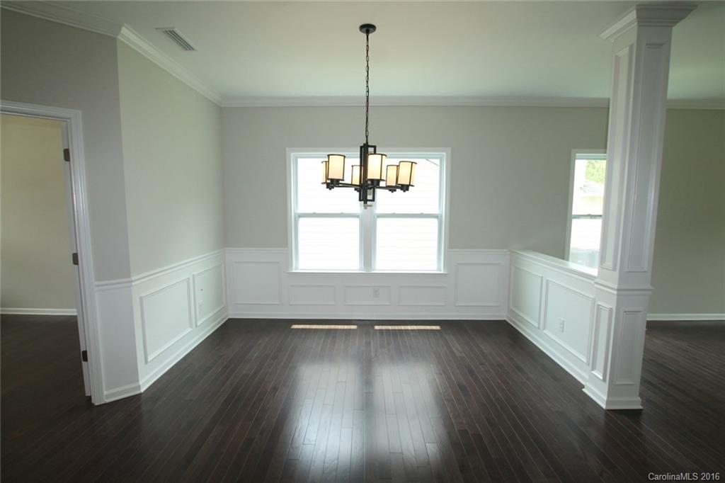 2269 Bluebell Way, Unit 26 Fort Mill, SC 29708 - Photo 3 of 21 a view of an empty room with wooden floor and a window
