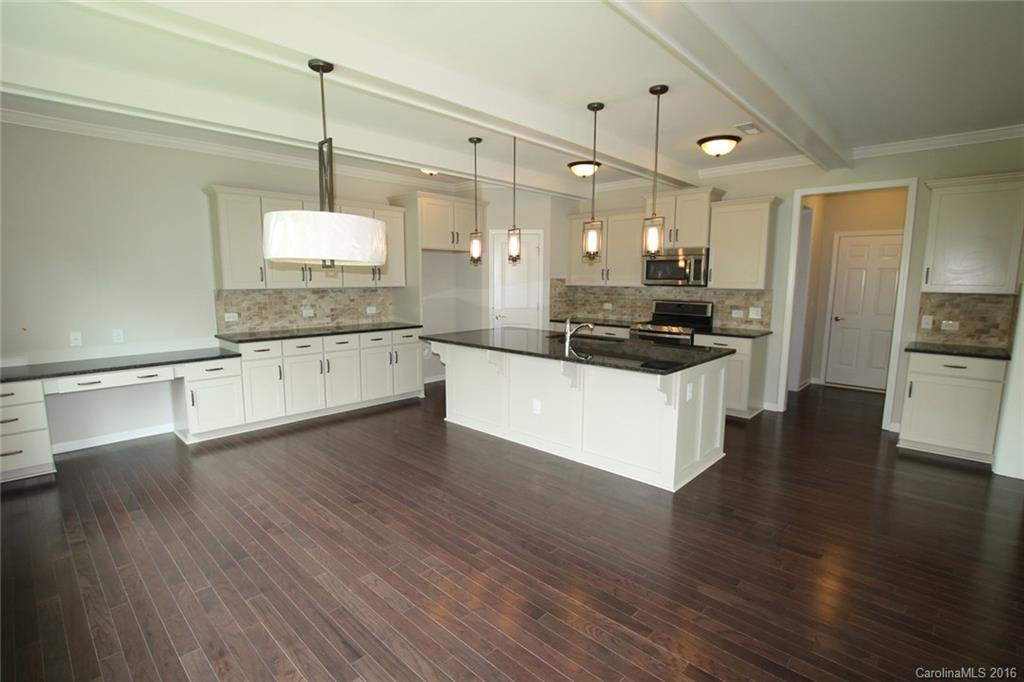 2269 Bluebell Way, Unit 26 Fort Mill, SC 29708 - Photo 7 of 21 a large kitchen with cabinets wooden floor and stainless steel appliances