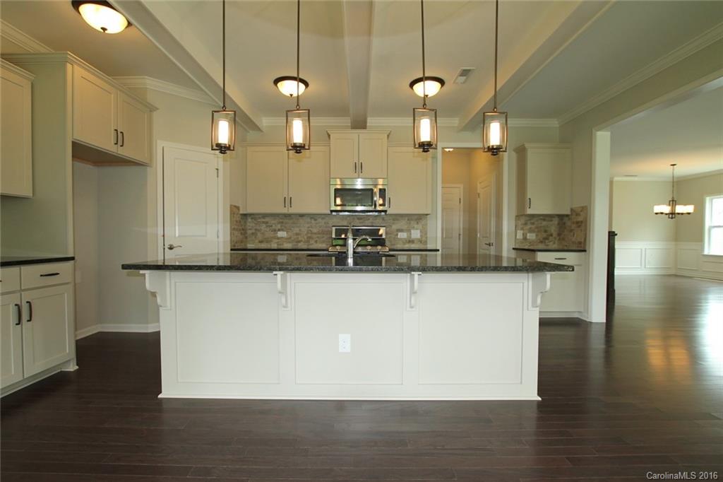2269 Bluebell Way, Unit 26 Fort Mill, SC 29708 - Photo 8 of 21 a large kitchen with stainless steel appliances kitchen island a large counter top space a sink and a chandelier