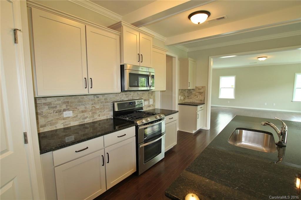 2269 Bluebell Way, Unit 26 Fort Mill, SC 29708 - Photo 9 of 21 a kitchen with stainless steel appliances granite countertop a stove a sink and a microwave