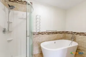 a bathroom with a bathtub and a shower