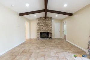 a view of an empty room with a fireplace